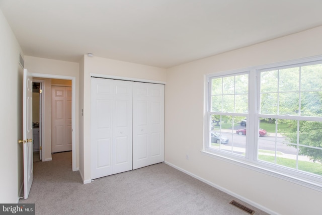 144 Carousel Cir, Doylestown, PA 18901 - unfurnished bedroom with multiple windows, light colored carpet, and a closet