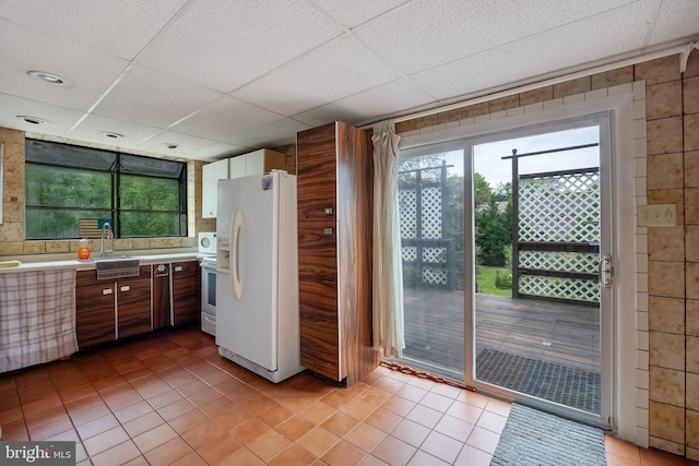 3962 Bensalem Blvd, Bensalem, PA 19020 - kitchen featuring white appliances, light tile patterned floors, light countertops, and a sink