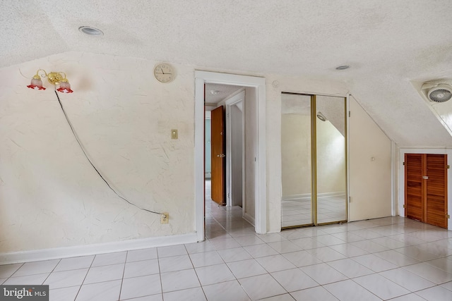 3962 Bensalem Blvd, Bensalem, PA 19020 - bonus room featuring a textured ceiling, lofted ceiling, light tile patterned floors, and baseboards