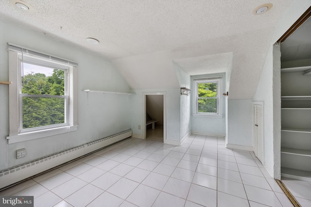 3962 Bensalem Blvd, Bensalem, PA 19020 - additional living space with a baseboard heating unit, a textured ceiling, lofted ceiling, healthy amount of natural light, and light tile patterned floors