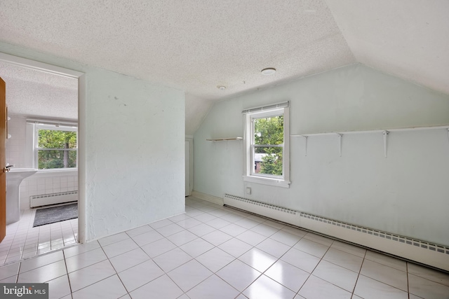 3962 Bensalem Blvd, Bensalem, PA 19020 - bonus room with a baseboard heating unit, vaulted ceiling, a textured ceiling, plenty of natural light, and tile patterned floors