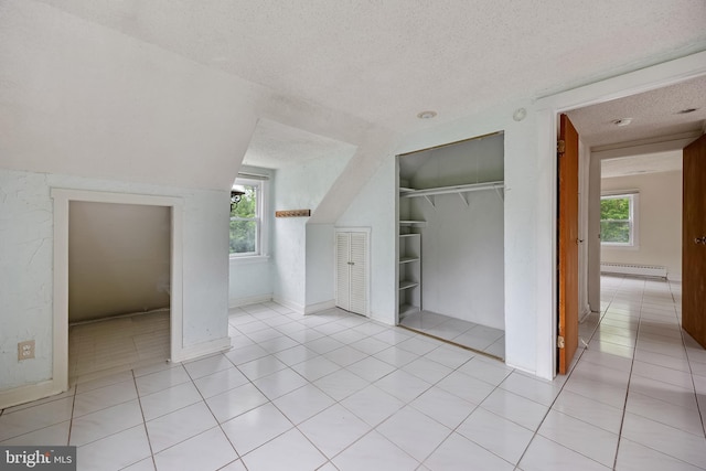 3962 Bensalem Blvd, Bensalem, PA 19020 - unfurnished bedroom with a textured ceiling, a baseboard heating unit, light tile patterned floors, and a closet