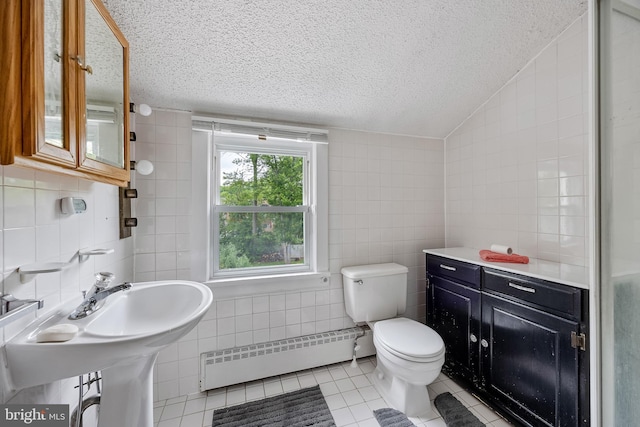 3962 Bensalem Blvd, Bensalem, PA 19020 - bathroom featuring a baseboard radiator, tile walls, tile patterned flooring, lofted ceiling, and a textured ceiling