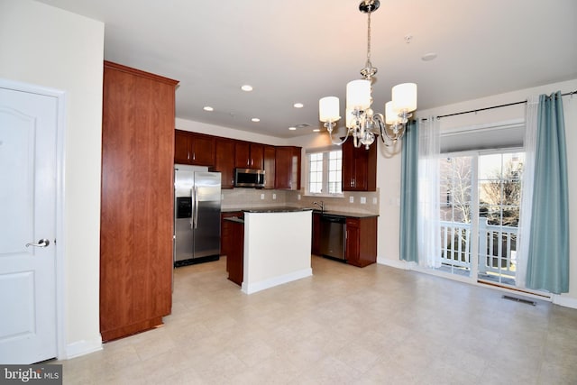 11665 Leesborough Cir, Silver Spring, MD 20902 - kitchen with appliances with stainless steel finishes, a chandelier, a kitchen island, decorative light fixtures, and recessed lighting