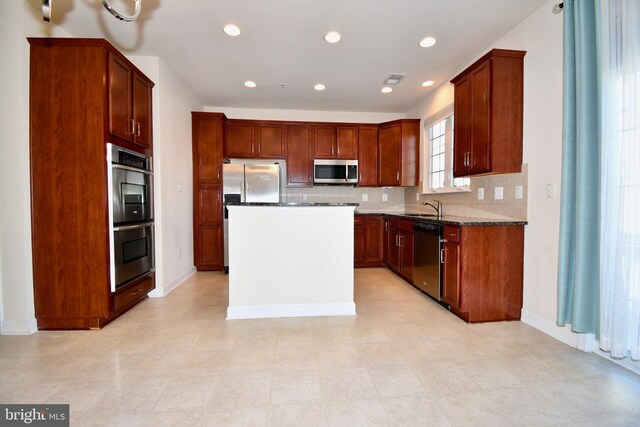 11665 Leesborough Cir, Silver Spring, MD 20902 - kitchen featuring appliances with stainless steel finishes, a sink, tasteful backsplash, a center island, and recessed lighting