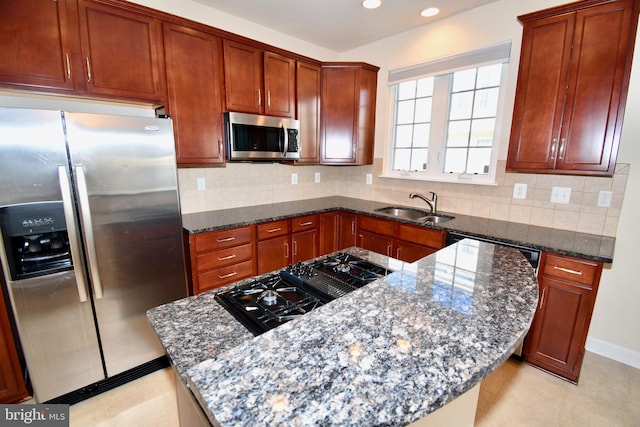 11665 Leesborough Cir, Silver Spring, MD 20902 - kitchen with appliances with stainless steel finishes, a sink, dark stone counters, backsplash, and recessed lighting