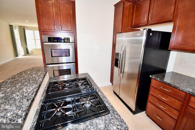 11665 Leesborough Cir, Silver Spring, MD 20902 - kitchen featuring appliances with stainless steel finishes, dark stone counters, and baseboards
