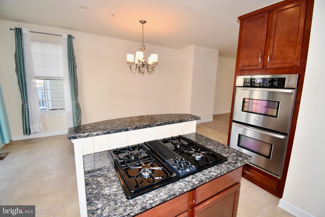 11665 Leesborough Cir, Silver Spring, MD 20902 - kitchen featuring black gas cooktop, stainless steel double oven, a chandelier, dark stone countertops, and baseboards