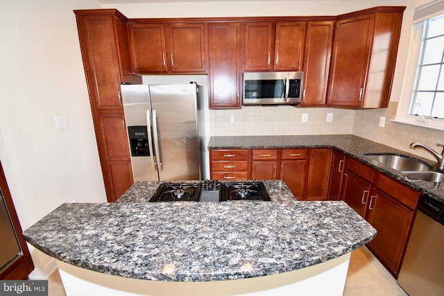 11665 Leesborough Cir, Silver Spring, MD 20902 - kitchen with appliances with stainless steel finishes, a sink, dark stone counters, and tasteful backsplash