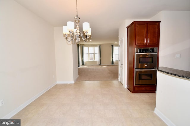 11665 Leesborough Cir, Silver Spring, MD 20902 - kitchen featuring stainless steel double oven, a chandelier, baseboards, hanging light fixtures, and dark stone counters