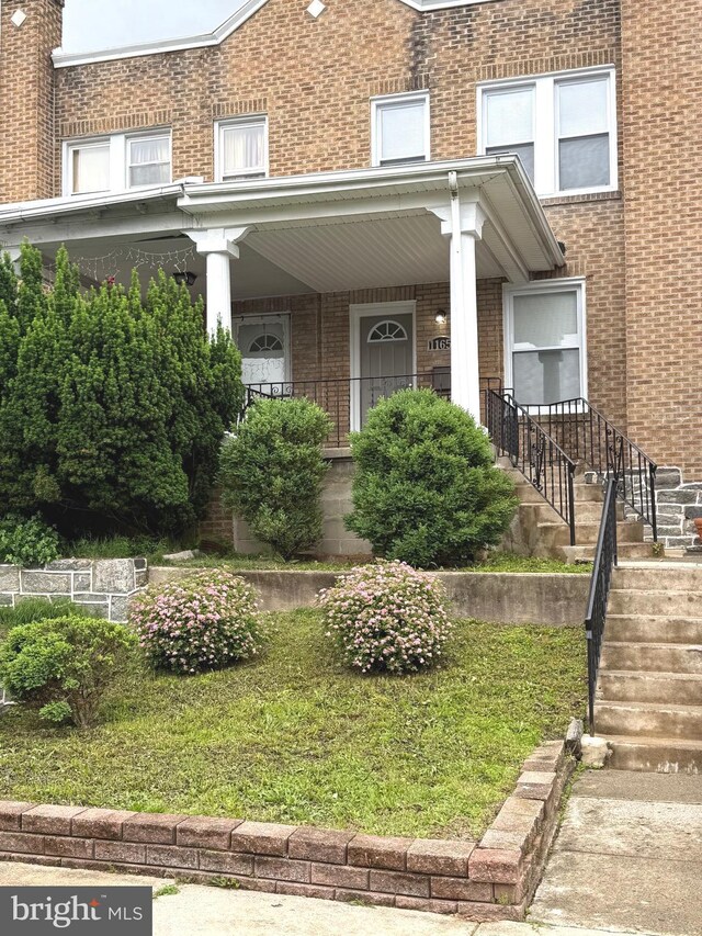 1165 Atwood Rd, Philadelphia, PA 19151 - doorway to property featuring brick siding and covered porch