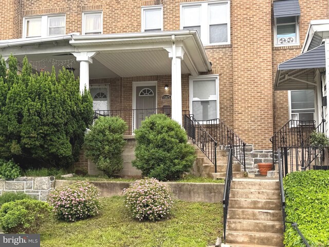 1165 Atwood Rd, Philadelphia, PA 19151 - doorway to property with brick siding and a porch