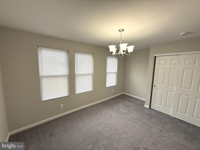 1165 Atwood Rd, Philadelphia, PA 19151 - empty room featuring a chandelier, dark carpet, baseboards, and a smoke detector