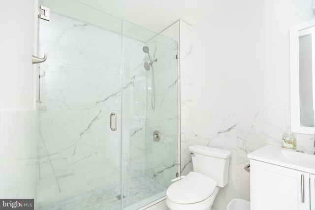 2331 Cambridge Cir, Hatfield, PA 19440 - bathroom featuring toilet, vanity, a marble finish shower, and tile walls