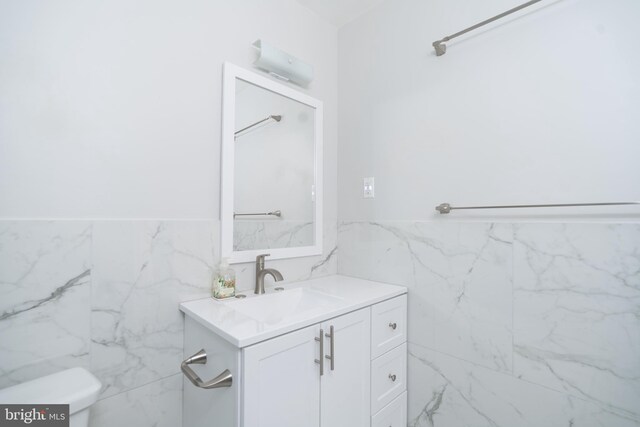 2331 Cambridge Cir, Hatfield, PA 19440 - bathroom with tile walls, vanity, toilet, and a wainscoted wall