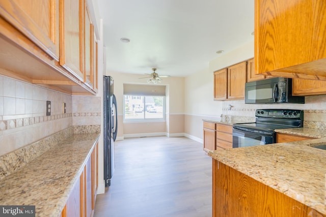 2331 Cambridge Cir, Hatfield, PA 19440 - kitchen with black appliances, backsplash, baseboards, and light wood finished floors