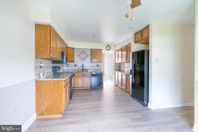 2331 Cambridge Cir, Hatfield, PA 19440 - kitchen with black appliances, backsplash, light wood finished floors, light stone counters, and baseboards