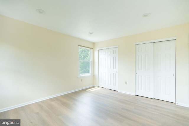 2331 Cambridge Cir, Hatfield, PA 19440 - unfurnished bedroom with multiple closets, light wood-type flooring, and baseboards