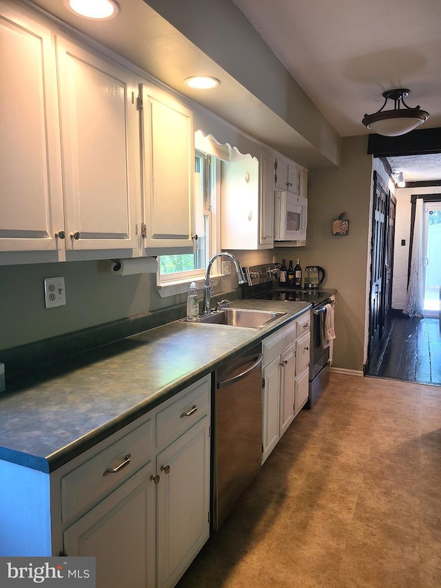 302 Old Lancaster Rd, Devon, PA 19333 - kitchen with electric range oven, dishwasher, a sink, white microwave, and plenty of natural light