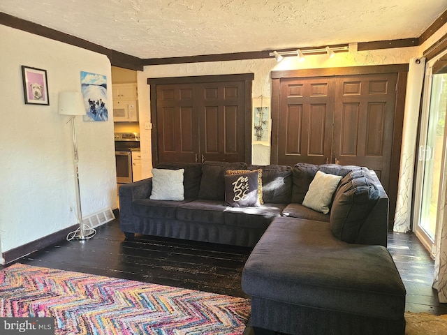 302 Old Lancaster Rd, Devon, PA 19333 - living room with a textured ceiling, hardwood / wood-style flooring, a textured wall, and baseboards