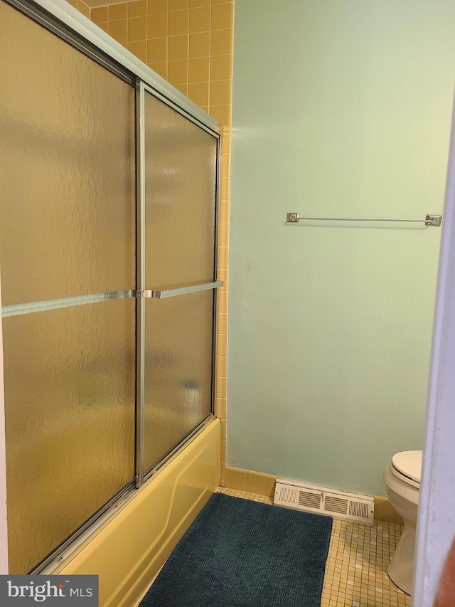 302 Old Lancaster Rd, Devon, PA 19333 - bathroom with toilet, tile patterned flooring, bath / shower combo with glass door, and baseboards