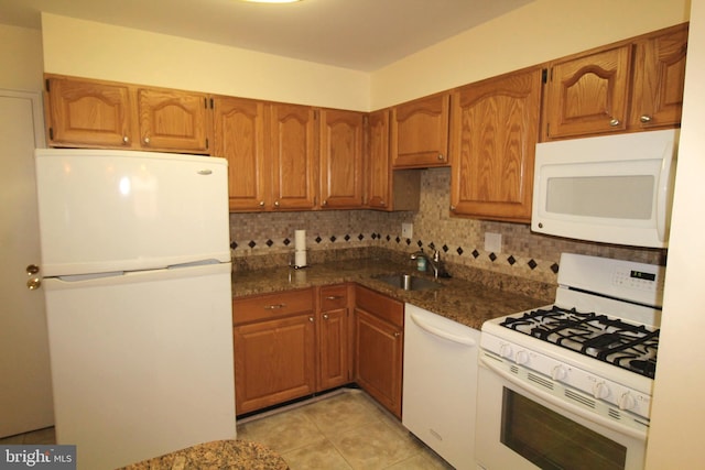 4801 Oxbow Rd, Rockville, MD 20852 - kitchen with white appliances, a sink, decorative backsplash, brown cabinets, and light tile patterned flooring