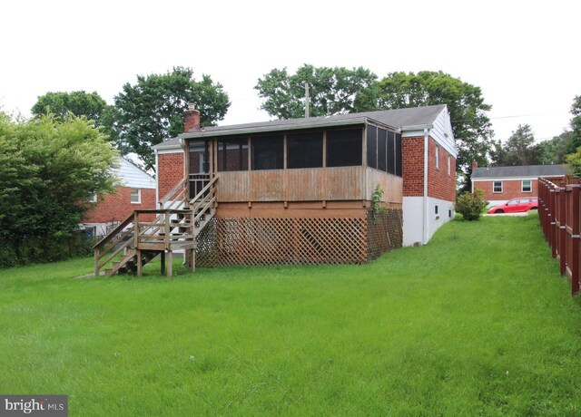 4801 Oxbow Rd, Rockville, MD 20852 - back of property featuring a sunroom, stairs, a lawn, and a chimney