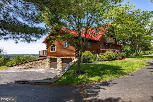 236 4th St, Herndon, PA 17830 - view of property exterior with log siding, asphalt driveway, a garage, stone siding, and a lawn