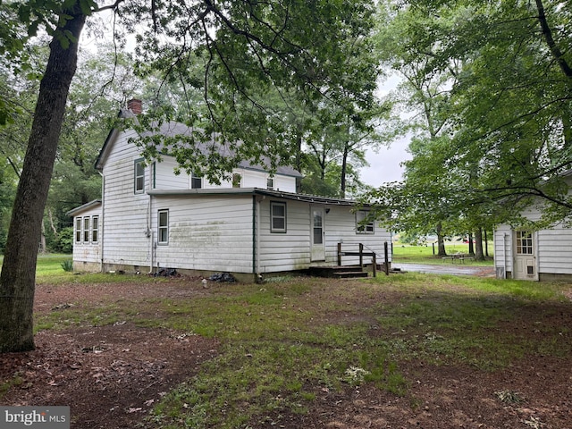81 Hollering Hill Rd, Camden Wyoming, DE 19934 - rear view of house featuring a chimney
