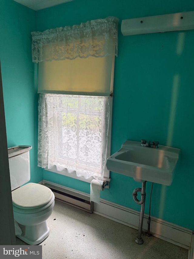 81 Hollering Hill Rd, Camden Wyoming, DE 19934 - bathroom with a baseboard radiator, toilet, and speckle patterned floor
