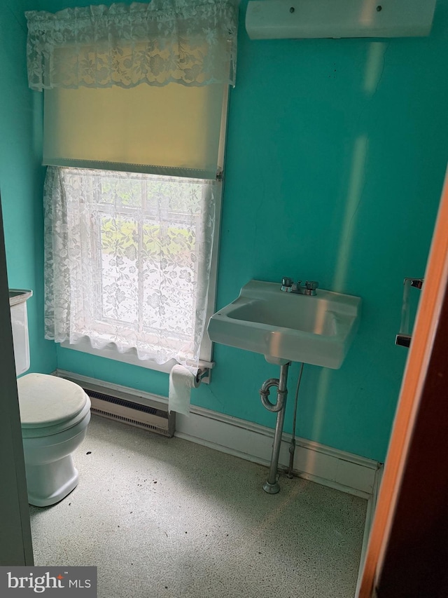 81 Hollering Hill Rd, Camden Wyoming, DE 19934 - bathroom with toilet, a baseboard heating unit, a sink, and baseboards