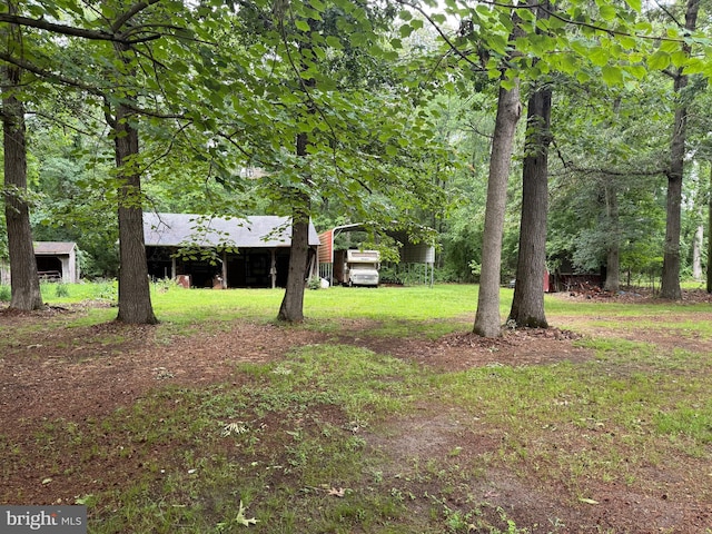 81 Hollering Hill Rd, Camden Wyoming, DE 19934 - view of green lawn featuring a carport