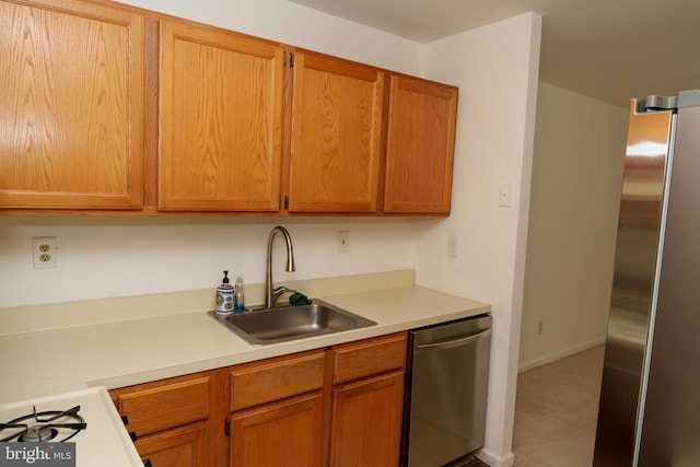 355 Norris Hall Ln Unit 355, Jeffersonville, PA 19403 - kitchen with stainless steel appliances, a sink, light countertops, and brown cabinets