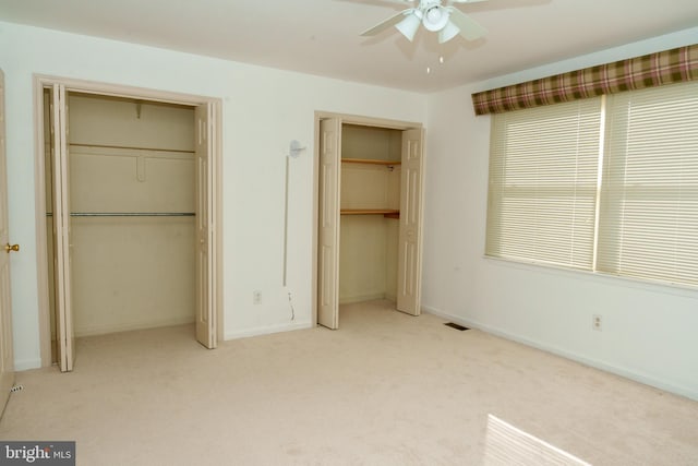 355 Norris Hall Ln Unit 355, Jeffersonville, PA 19403 - unfurnished bedroom featuring two closets, carpet floors, baseboards, and a ceiling fan