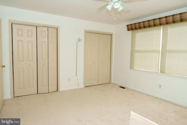 355 Norris Hall Ln Unit 355, Jeffersonville, PA 19403 - unfurnished bedroom featuring two closets, carpet, baseboards, and ceiling fan