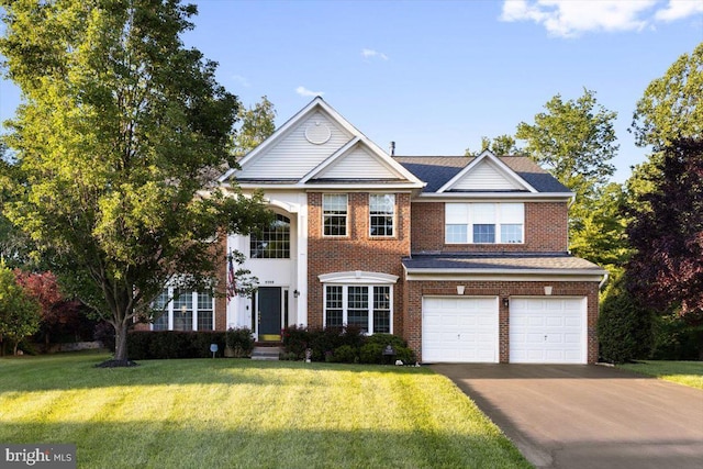9308 Eagle Ct, Manassas Park, VA 20111 - view of front facade featuring asphalt driveway, an attached garage, brick siding, and a front lawn