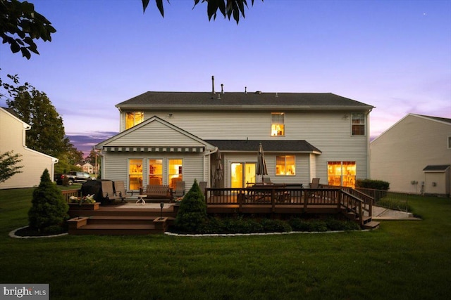 9308 Eagle Ct, Manassas Park, VA 20111 - back of house at dusk featuring a wooden deck and a lawn