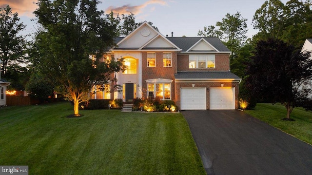 9308 Eagle Ct, Manassas Park, VA 20111 - view of front of property featuring driveway, an attached garage, a front yard, and brick siding