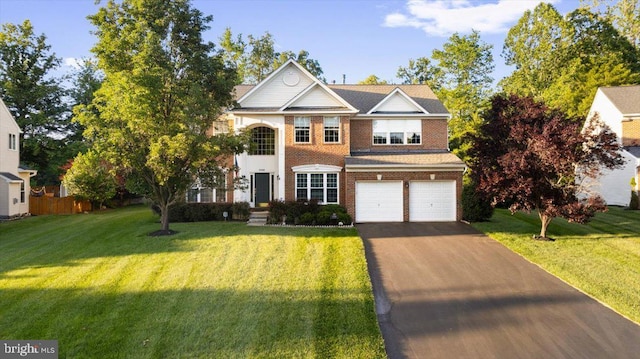 9308 Eagle Ct, Manassas Park, VA 20111 - view of front of house featuring asphalt driveway, an attached garage, a front lawn, and brick siding