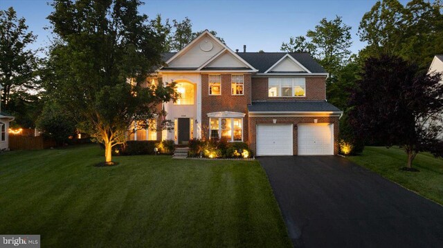 9308 Eagle Ct, Manassas Park, VA 20111 - traditional-style house with driveway, an attached garage, a front yard, and brick siding