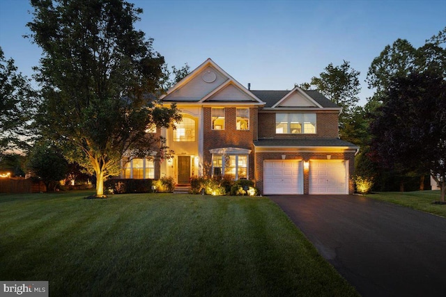 9308 Eagle Ct, Manassas Park, VA 20111 - view of front of property with asphalt driveway, an attached garage, a front yard, and brick siding