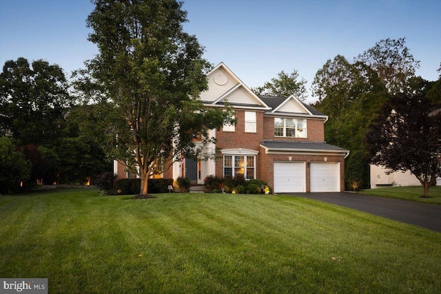 9308 Eagle Ct, Manassas Park, VA 20111 - view of front of property with driveway, an attached garage, a front yard, and brick siding