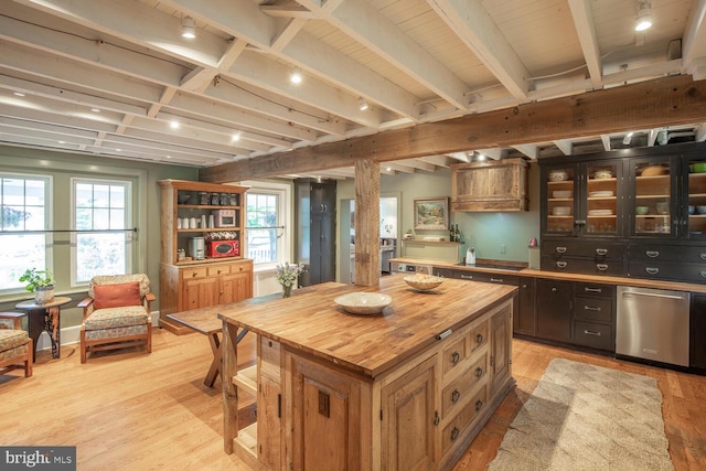 448 Old Dublin Pike, Doylestown, PA 18901 - kitchen featuring stainless steel dishwasher, butcher block counters, light wood-style floors, beam ceiling, and glass insert cabinets