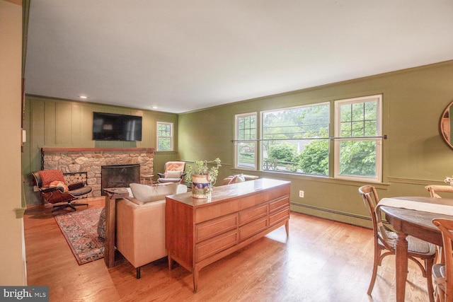 448 Old Dublin Pike, Doylestown, PA 18901 - living room featuring a baseboard heating unit, light wood finished floors, ornamental molding, and a fireplace
