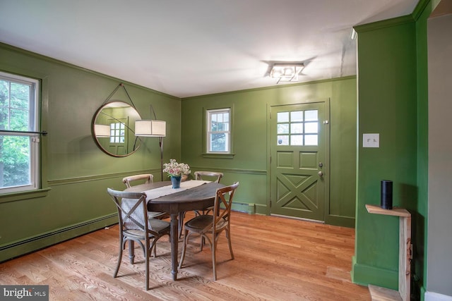 448 Old Dublin Pike, Doylestown, PA 18901 - dining room featuring baseboard heating, crown molding, healthy amount of natural light, light wood finished floors, and a decorative wall