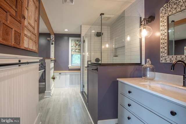 448 Old Dublin Pike, Doylestown, PA 18901 - bathroom with a stall shower, wood finished floors, vanity, radiator, and recessed lighting