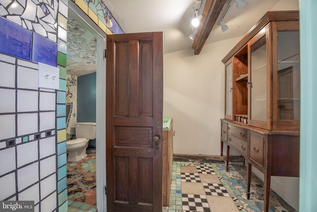 448 Old Dublin Pike, Doylestown, PA 18901 - bathroom featuring vanity, toilet, tile patterned floors, baseboards, and rail lighting