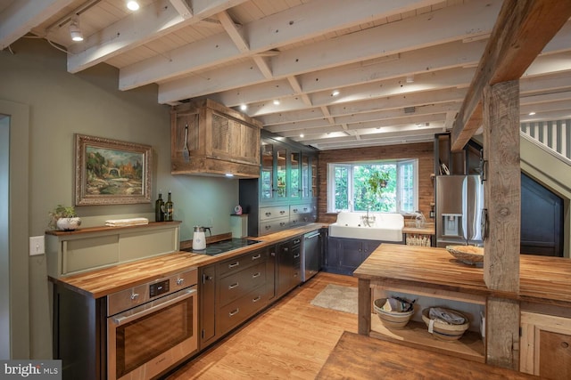 448 Old Dublin Pike, Doylestown, PA 18901 - kitchen with wood counters, appliances with stainless steel finishes, light wood finished floors, a sink, and wood ceiling with exposed beams