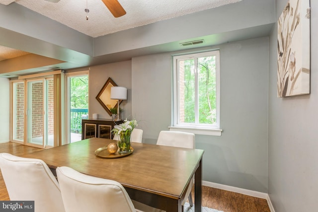 11833 Shire Ct Unit 12C, Reston, VA 20191 - dining area with baseboards, a textured ceiling, wood finished floors, and a ceiling fan
