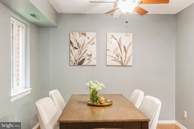 11833 Shire Ct Unit 12C, Reston, VA 20191 - dining room with a ceiling fan, baseboards, and a textured ceiling